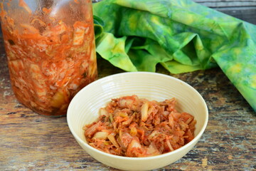 Napa cabbage kimchi in a bowl, Korean fermented side dish food.
