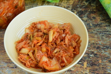 Napa cabbage kimchi in a bowl, Korean fermented side dish food.
