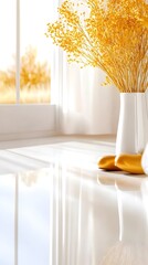 Sunlit windowsill scene with a white vase holding dried golden-yellow flowers, and gold decorative objects reflecting on a glossy white surface