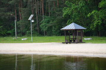 Wooden gazebo for outdoor recreation in the countryside near the lake