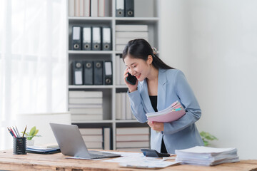 Smiling Asian Businesswoman on Phone in Office