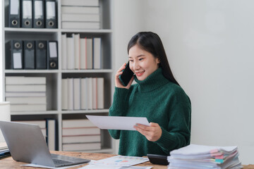 Smiling Asian Woman Working at Desk