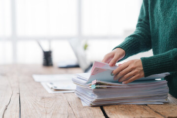 Woman Sorting Through Stack of Documents