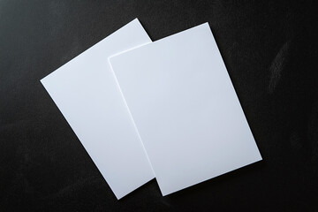Blank sheets of paper float on a dark background