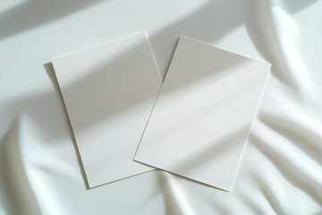 Blank sheets of paper overlapping gently on a soft surface