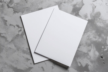 Blank sheets of paper on a textured surface for creative projects