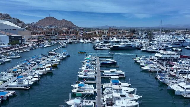 Aerial Cabo San Lucas Mexico marina to city 1. Resort city southern tip of Baja California peninsula. Beach and malecon markets. Eco tourism. Destination vacation and business. Commercial seaport.