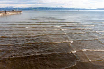 A serene yet dynamic view of Lake Constance (Bodensee) at Langenargen, on a bright day. Gentle waves, with subtle whitecaps