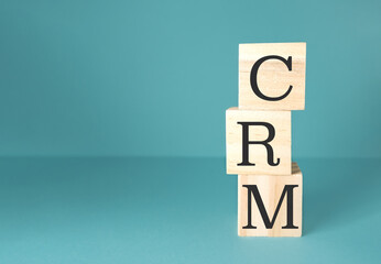Stack of wooden blocks with the letters CRM on top