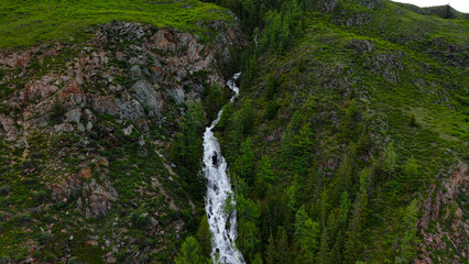 Beautiful mountain waterfall. Large waterfall in the Altai Republic, cinematic views of a large...