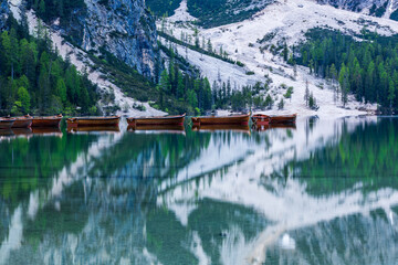 Fototapeta premium Empty boats at dawn on Lago di Braies in the Italian Dolomites