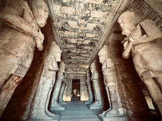 Interior view with giant statues of Ramses II Abu Simbel temple, ancient Egypt