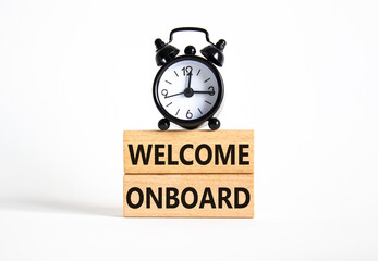 Welcome onboard symbol. Concept words Welcome onboard on wooden blocks. Beautiful white background with alarm clock. Business and Welcome onboard concept. Copy space.