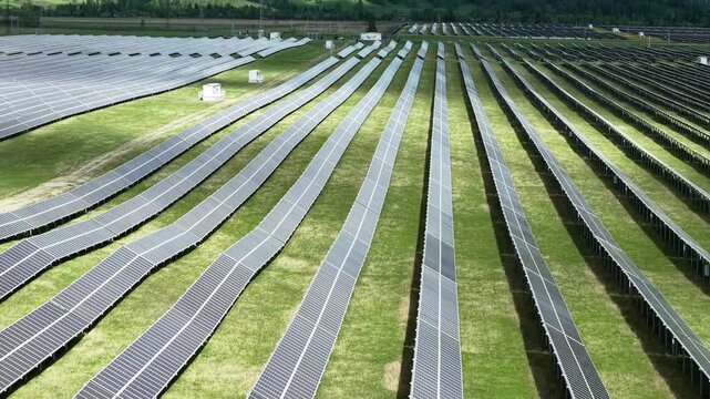 Solar power plant in the mountains. Thousands of solar panels. Renewable energy in remote mountainous regions. Clean energy from the sun. Rows of solar panels at a power plant.