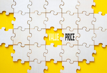 Price and Value symbol. Concept word Price and Value on wooden puzzle. Beautiful yellow background....