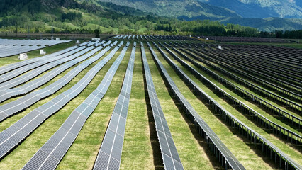 Solar power plant in the mountains. Thousands of solar panels. Renewable energy in remote...