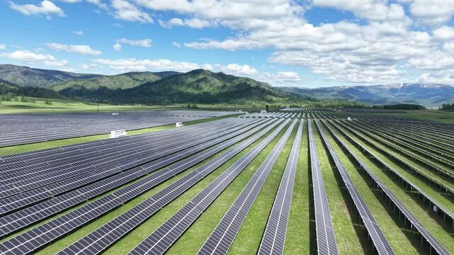 Solar power plant in the mountains. Thousands of solar panels. Renewable energy in remote mountainous regions. Clean energy from the sun. Rows of solar panels at a power plant.