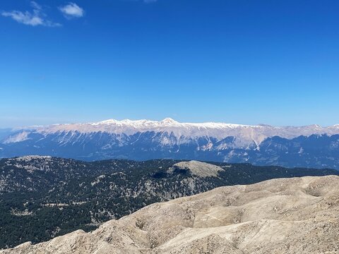 Panoramic view of snowy mountains and hills from the peak of Tahtali. Olympos Teleferik, Tahtali 2365m, Kemer, Antalya. Sea to sky.
