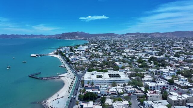 Aerial La Paz Mexico city along ocean bay 1. Capital Mexican state of Baja California Sur, peninsula. Ferry, fishing, cargo and cruise ships. Beach Malecon markets. Eco tourism economy.
