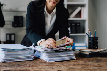 Businesswoman Organizing Documents at Desk