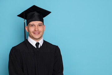 Happy student after graduation on light blue background. Space for text