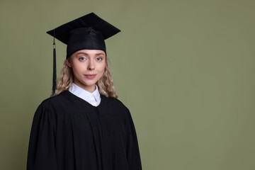 Student after graduation on green background. Space for text