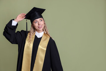 Happy student after graduation on green background. Space for text