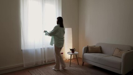 Woman feeling better after depression opens curtains