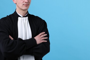 Judge on light blue background, closeup. Space for text