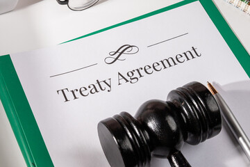 Treaty Agreement Document on Desk with Gavel and Pen – International Law Concept


