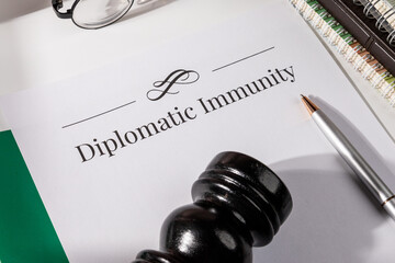 Diplomatic Immunity Document with Gavel and Pen on Desk