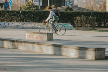 young man on the street riding on vintage bicycle