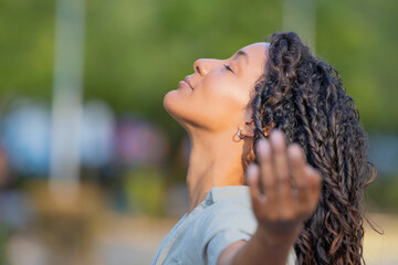 portrait of beautiful young latina woman breathing relaxed outdoors