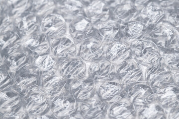 Bubble wrap macro photo with selective focus. It is a pliable transparent plastic material with...
