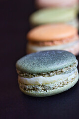 Row of macarons of different colors: beautiful depth of field and color contrast.