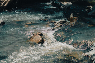 Water flowing creek on the rocks in a beautiful river landscape