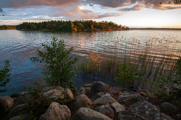 Island on the lake under a cloudy sky after rain