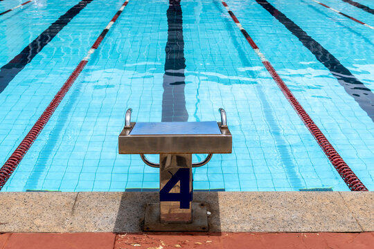 Starting platforms with number 4 for swimming races and competitions in Brazil. Swimming pool starting block No.4. Sport and swimming concept