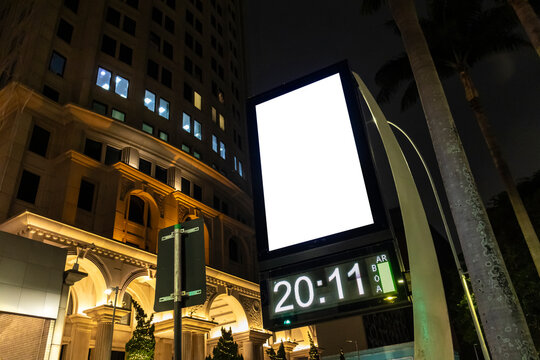 Billboard blank mock up on a digital street clock in the city of Sao Paulo. Use this photo day mockup for your outdoor design.