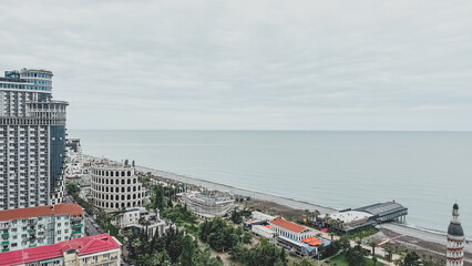 Coastal view of Batumi, Georgia with modern architecture, beach promenade and calm sea under an...
