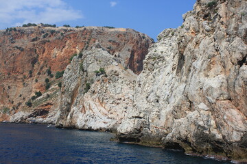 Majestic rocky cliffs rising above the blue ocean under a clear sky