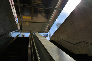 Stairs and escalators leading from the underground shopping mall to the ground
