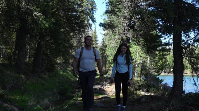 Traveling in the forest. A couple walks through a dense forest during a hiking trip in the Altai Mountains. Backpacking, forest scene