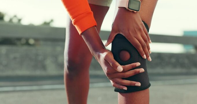 Hands, fitness and athlete with knee brace outdoor for pain management, exercise and joint support. Runner, person and kneecap protection for marathon practice, cardio workout and sprain recovery