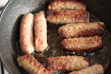 A balkan traditional meatball dish cevapi, cevapcici  on wooden table in close-up	