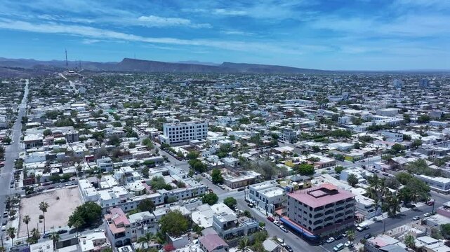 Aerial La Paz Mexico city business center to bay 1. Capital Mexican state of Baja California Sur, peninsula. Ferry, fishing, cargo and cruise ships. Beach Malecon markets. Eco tourism economy.
