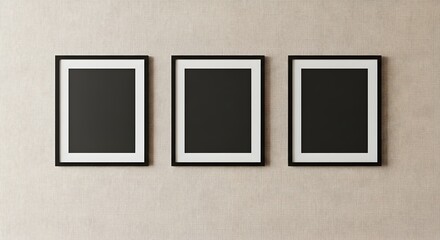 Three framed artworks on textured wall
