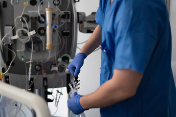Doctor preparing medical equipment for blood transfusion or donation in hospital