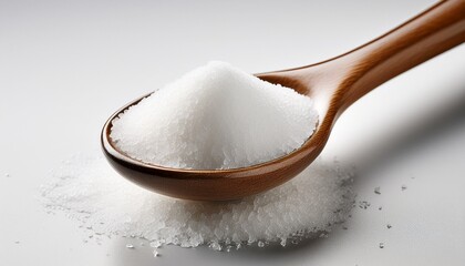 spoonful of white sugar against white backdrop granulated spoon
