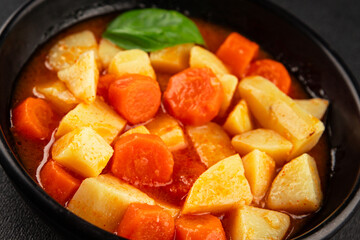 Stewed potatoes with carrots vegetarian side dish fresh delicious gourmet food background on the table rustic food top view copy space keto and paleo diet vegan food